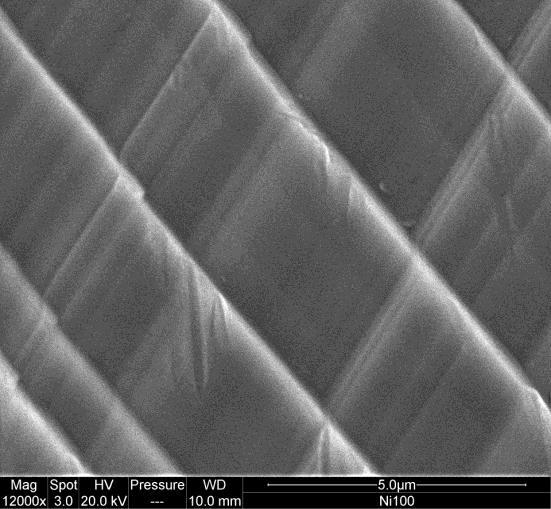) MEB (échelle du µm): bandes (à gauche) formées par des marches (détail, à droite)